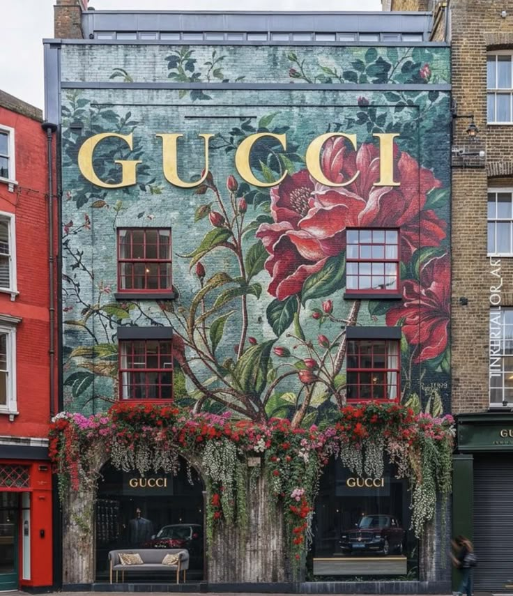 a large building with flowers painted on it's side in front of other buildings