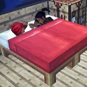 two stuffed animals laying on top of a bed in a room with a red blanket