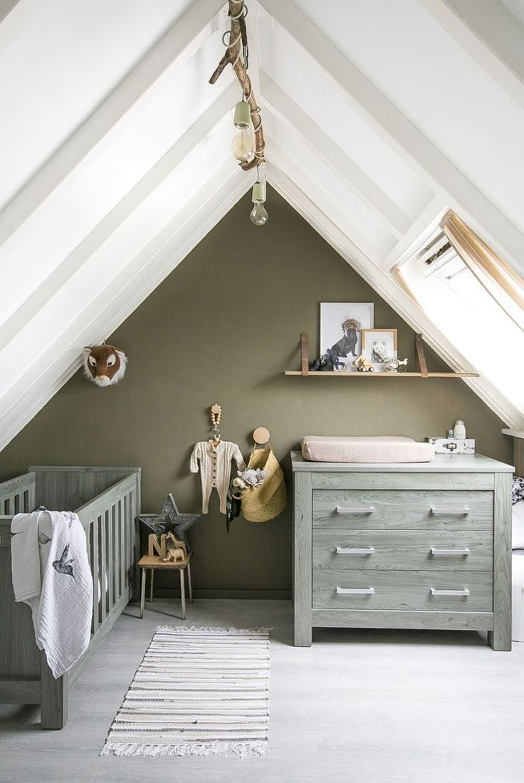 a baby's room with a crib, dresser and bed in the corner