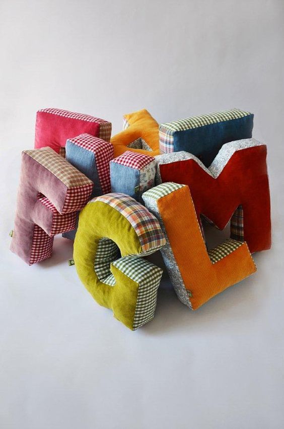 the letters are made out of different colored pillows