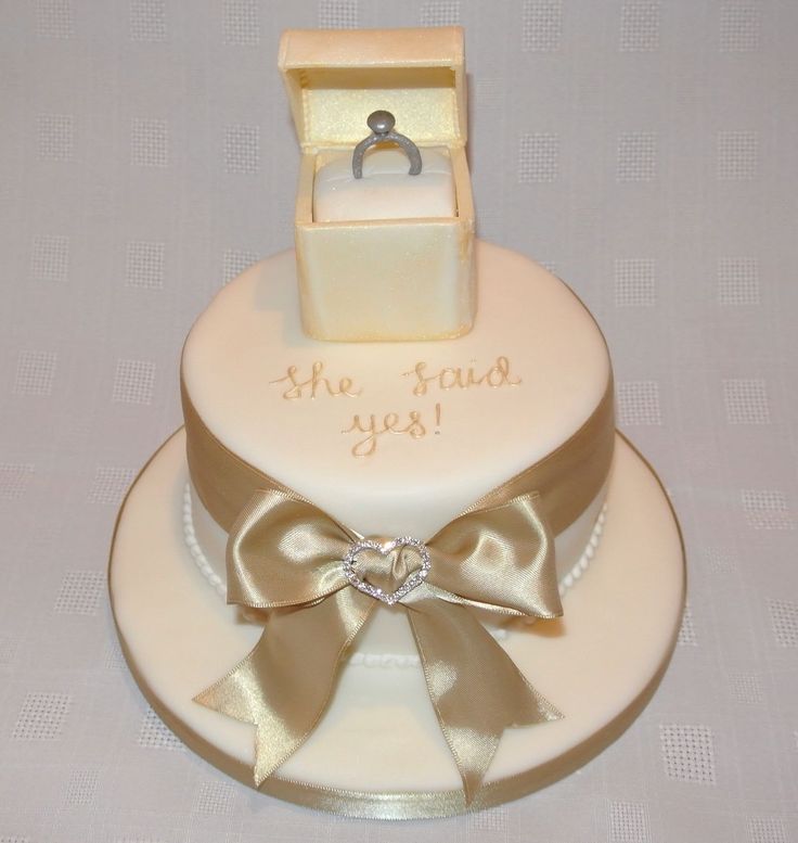 a wedding cake decorated with an engagement ring and the words, the friend you're