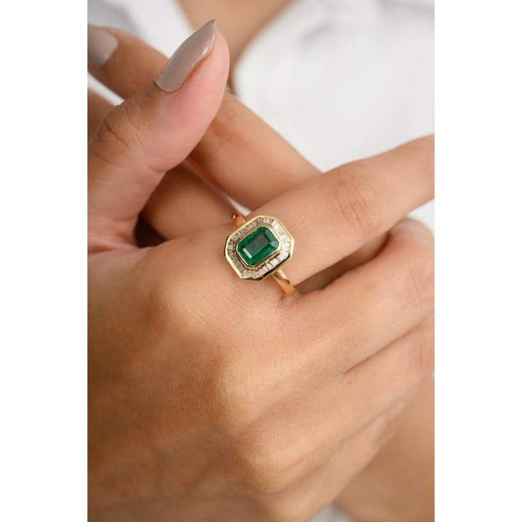 This 18k gold statement ring showcases an octagon-cut center emerald, surrounded by a dazzling baguette-cut diamond halo. The vibrant green emerald contrasts beautifully with the sparkling diamonds, creating a captivating and luxurious piece. Perfect for special occasions, this ring exudes sophistication and timeless elegance, making it a must-have addition to any jewelry collection. Emerald enhances intellectual capacity of the person.  Designed with octagon cut emerald set with halo diamonds t Heirloom Emerald Ring, Emerald Engagement Ring Art Deco, Emerald Stone Engagement Ring, Baguette Halo, Emerald Band Ring, Vintage Cocktail Rings, Emerald Set, Mom Wedding Gift, Emerald Wedding Rings