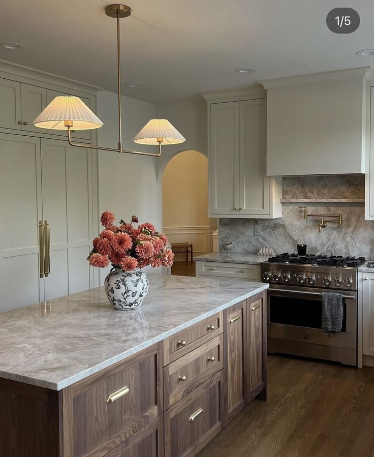 a large kitchen with an island, stove and sink in it's center area