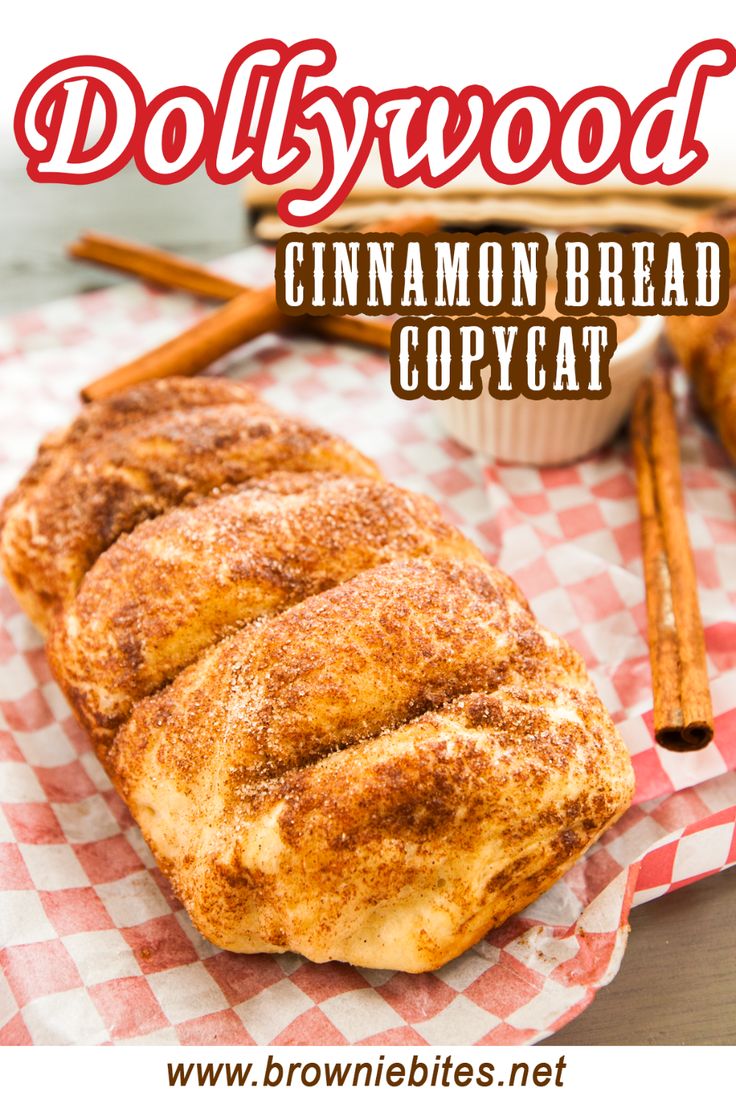 cinnamon bread is sitting on top of a red and white checkered napkin with cinnamon sticks