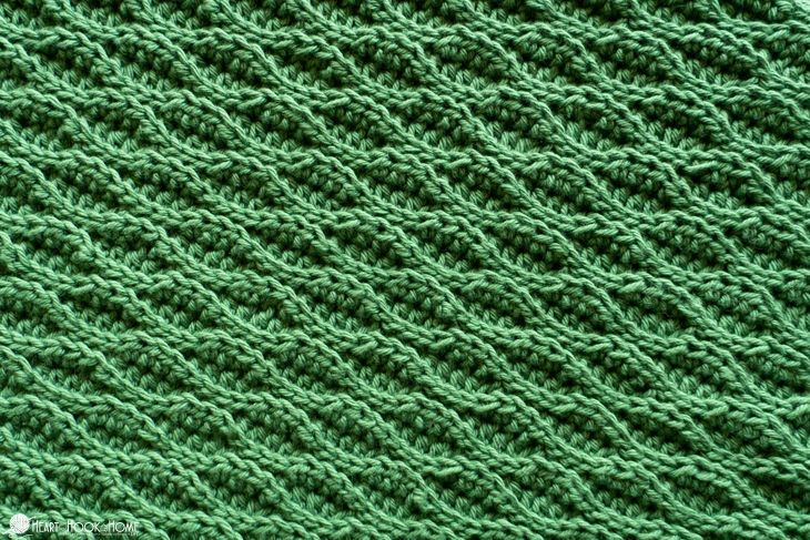 green knitted fabric close up with the stitching down to it's edges