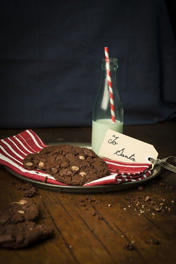 a glass bottle and some cookies on a table