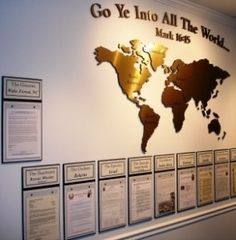 a wall with a map on it that says go ye into all the world,