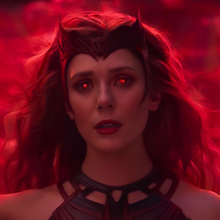 a woman with red eyes and horns in a scene from the movie maleficent