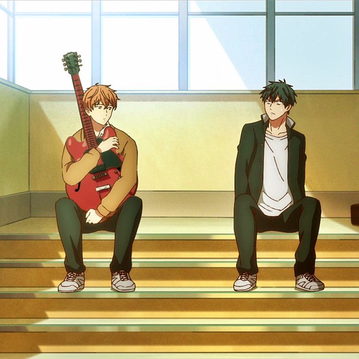 two young men sitting on steps with guitars