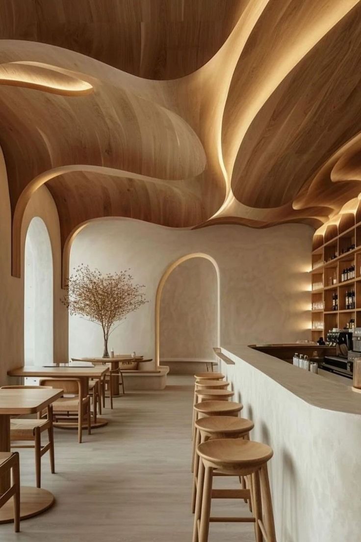 an empty restaurant with wooden tables and stools