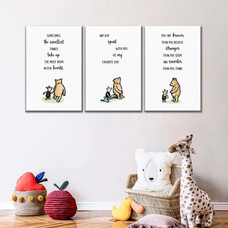 three winnie the pooh prints hanging on a wall next to stuffed animals and toys