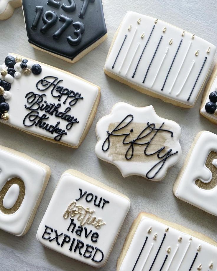 decorated cookies are arranged on a table with the words happy birthday written in black and white