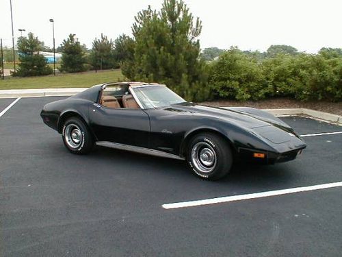 a black sports car parked in a parking lot