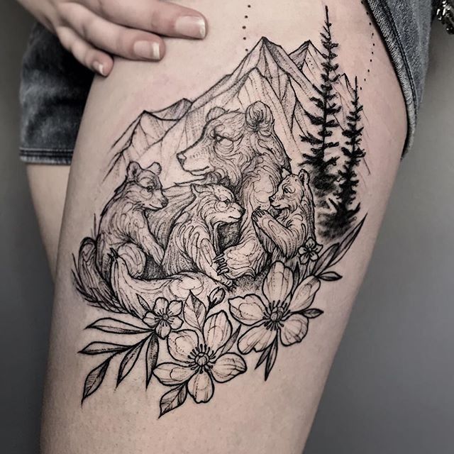 a woman's thigh with an image of two bears and flowers on the side