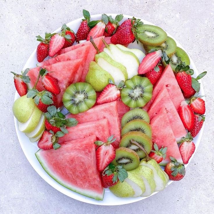 watermelon, kiwi and strawberries arranged on a plate