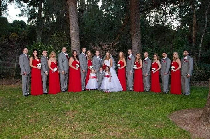 a large group of people dressed in red and grey posing for a photo with each other