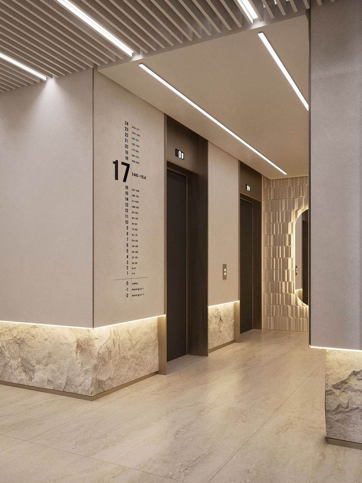 an empty lobby with two elevators and numbers on the wall