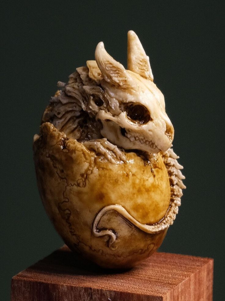 a carved animal head sitting on top of a wooden block