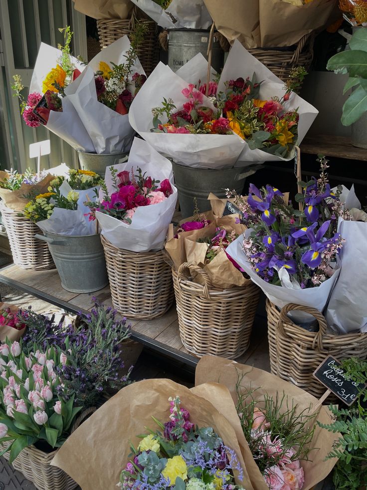 baskets filled with flowers sitting on top of a table