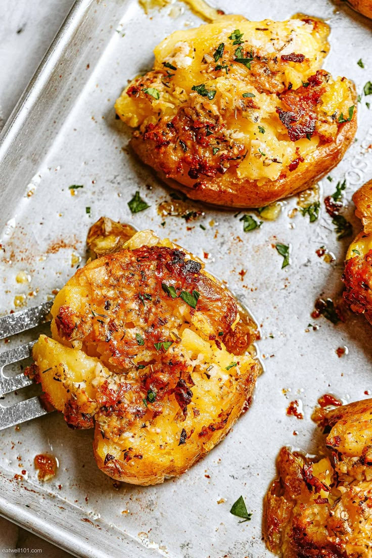 some food that is sitting on a pan with a fork in it and one has been cooked