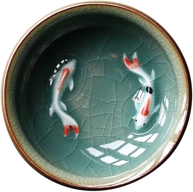 two koi fish swimming in a green bowl