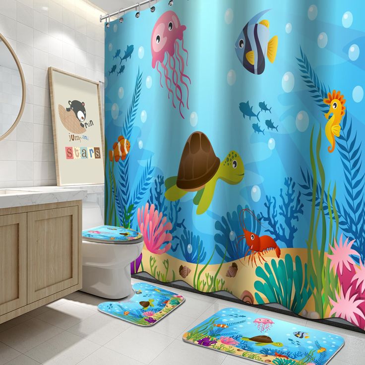 a bathroom with blue shower curtains and colorful underwater themed rugs