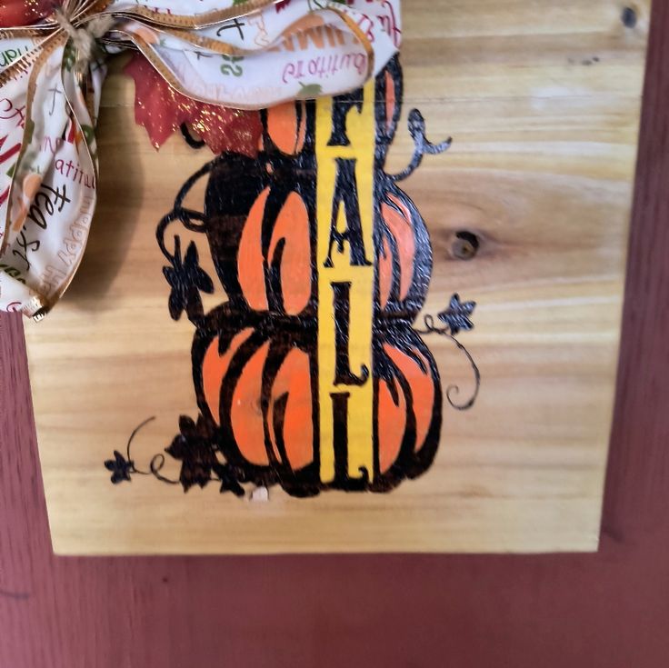 a wooden cutting board with an orange and black pumpkin on it that says happy halloween