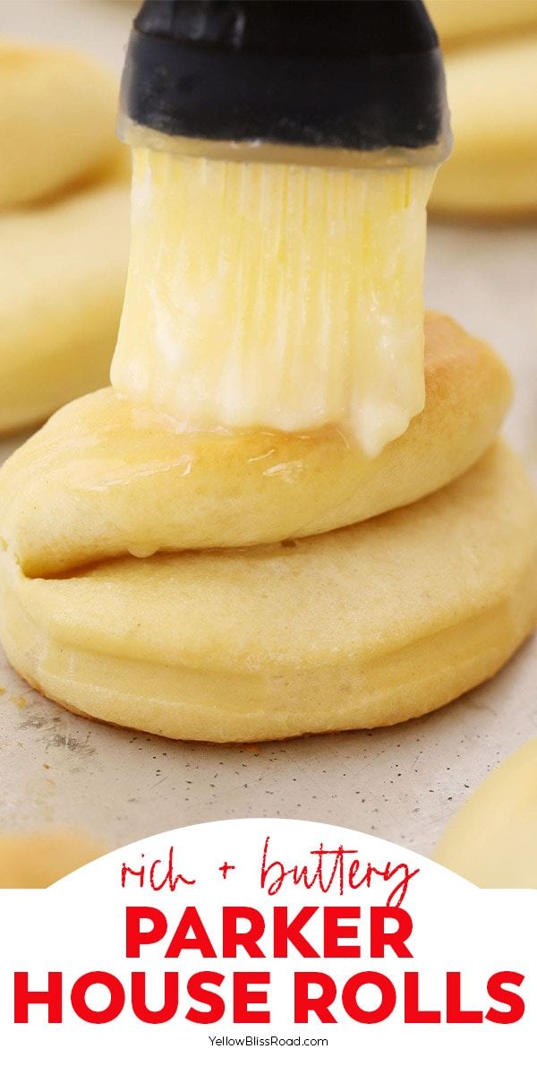 a close up of a brush on top of some cookies with the words rid buttery parker house rolls