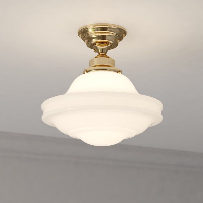 a white light hanging from the ceiling in a room