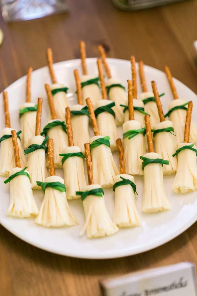 small appetizers are arranged on a plate with green ribbon around the stems and leaves