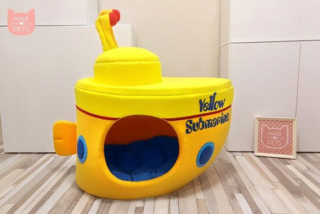 a yellow submarine shaped dog house with a toothbrush sticking out of it