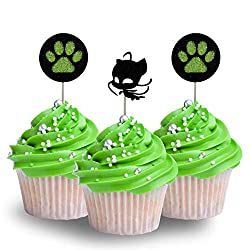 three cupcakes with green frosting and black cat toppers on them, one is