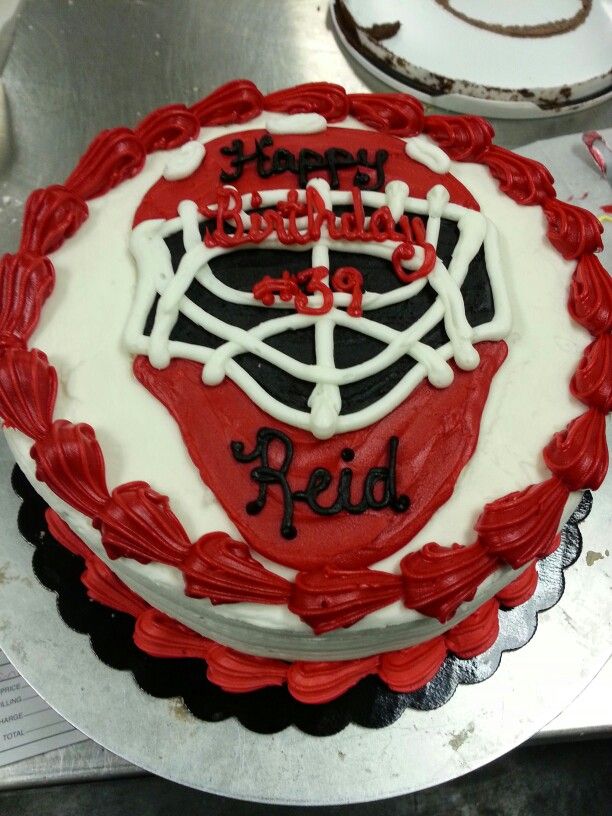 a red and white birthday cake sitting on top of a table