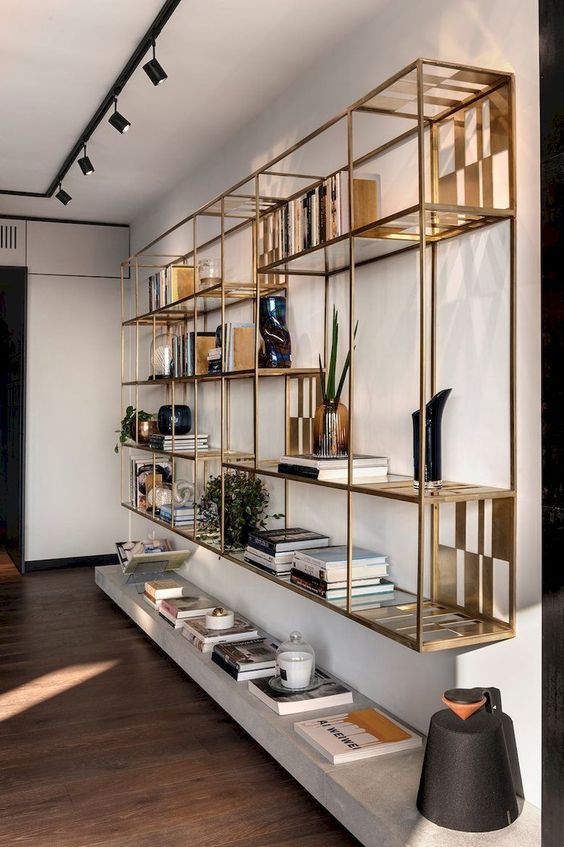 the shelves are filled with books and other items in this modern living room, which also has wood flooring