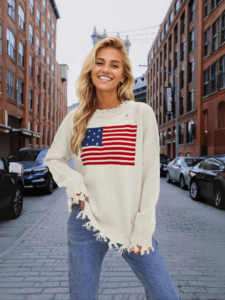 Stand out in style with our American Flag Relaxed Knit Sweater! This quirky and fun sweater features the iconic stars and stripes design, adding a playful touch to your look. Stay comfortable and show off your patriotic side with this cozy and unique sweater. Size Guide: Model is 5’7” tall, and has a 32.7” bust, 24.6”waist, & 36.2” hips. She is wearing a S / US 4 / AU 8. This sweater is true to size. Feature: Ripped crew neckline. Long sleeves. Ripped knit fabrication details. Not lined. Oversized Relaxed Fit. Material: 100% Acrylic. Care Instructions: Machine wash / Cold hand wash. White Crew Neck Sweater With Star Print, Fall White Sweater With Star Print, White Star Print Sweater For Fall, Casual Crew Neck Sweater With Star Print, Casual Fall Sweater With Star Print, Spring Americana Long Sleeve Tops, Fall Flag Print Long Sleeve Sweater, Long Sleeve Flag Print Sweater For Fall, Americana Long Sleeve Sweater For Fall