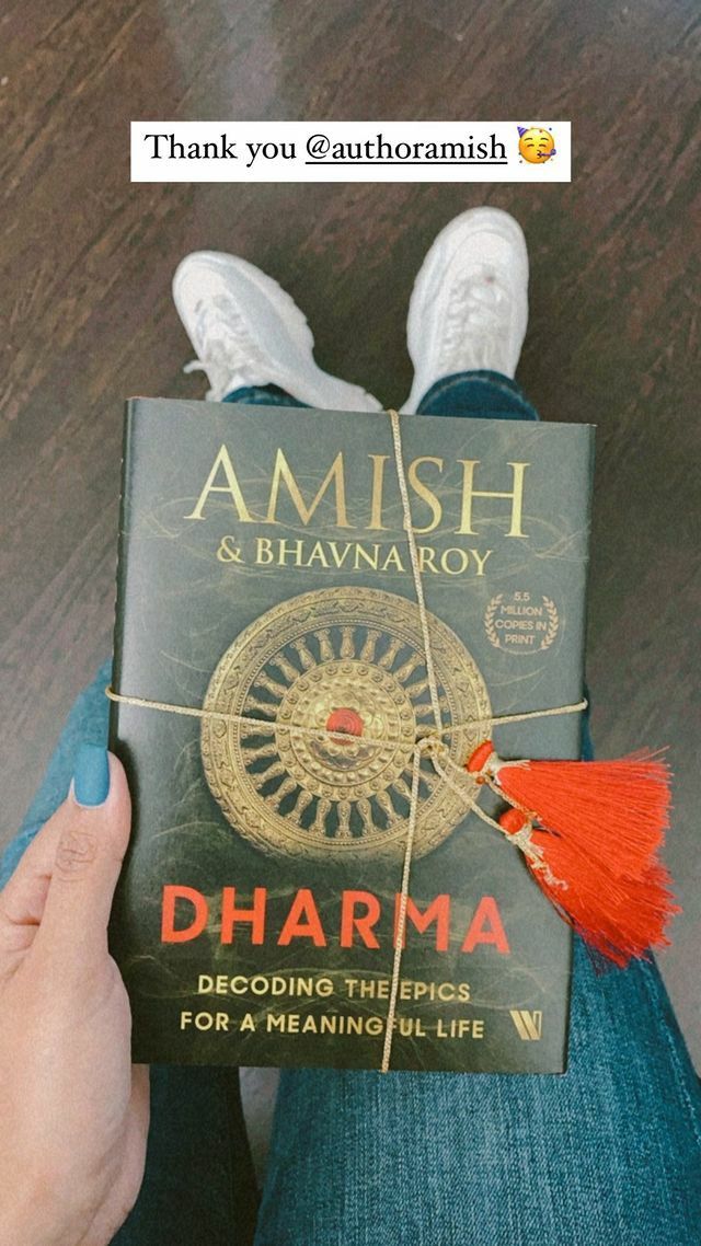 someone holding a book in their hands with the title amish and bihanaroy dharma