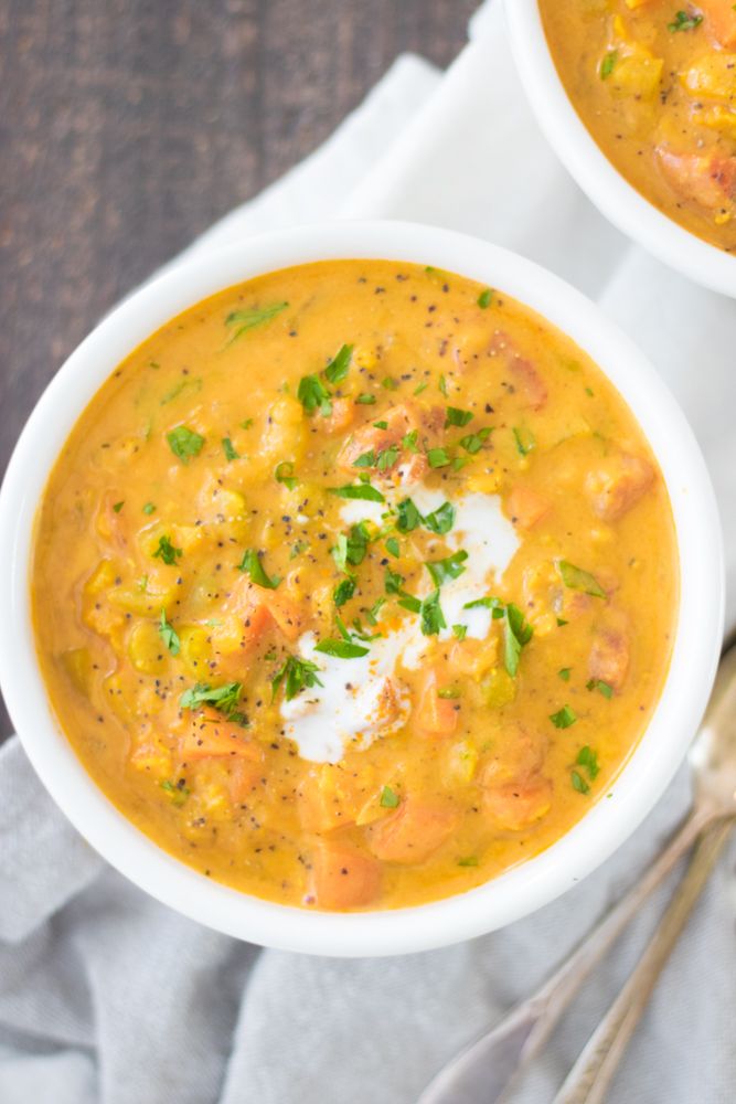 two white bowls filled with soup on top of a table