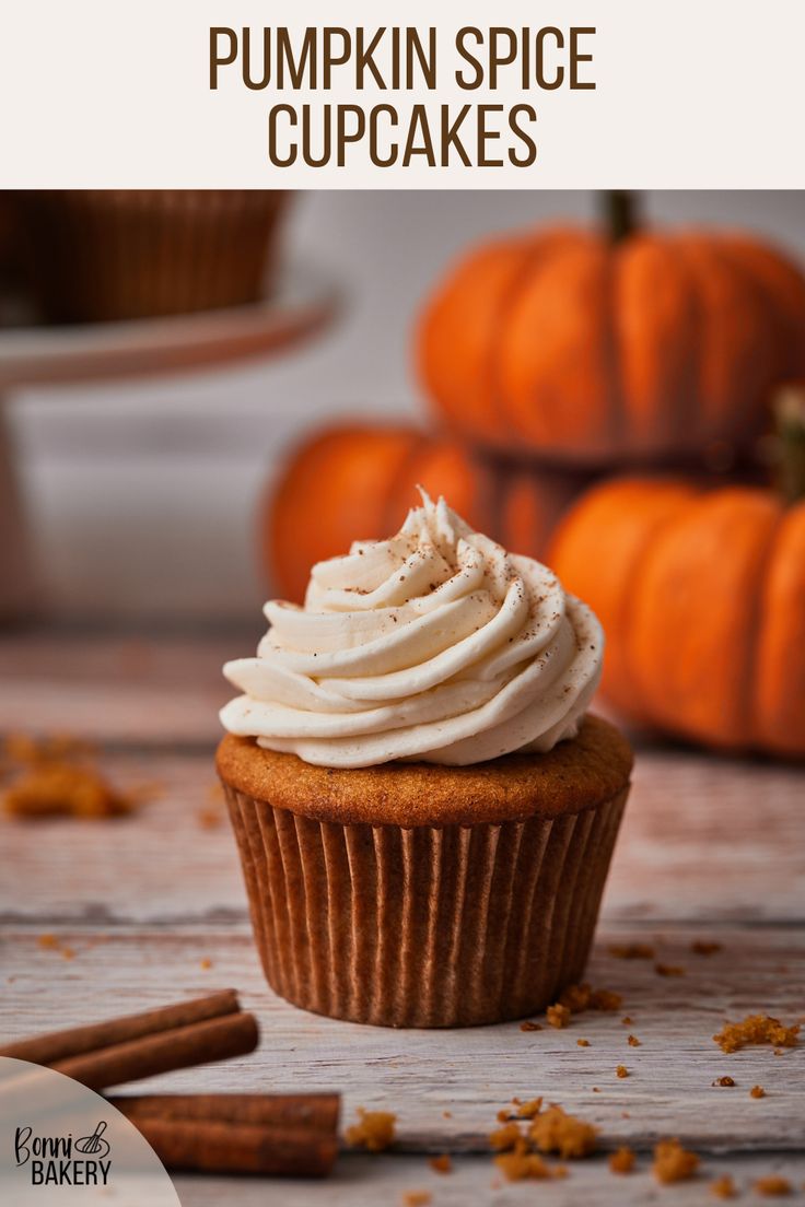 pumpkin spice cupcakes with cream cheese frosting and cinnamon sticks on the side