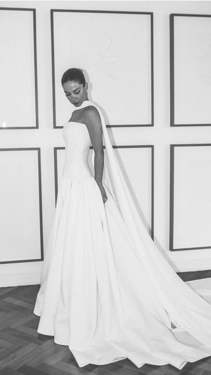 a black and white photo of a woman in a wedding dress