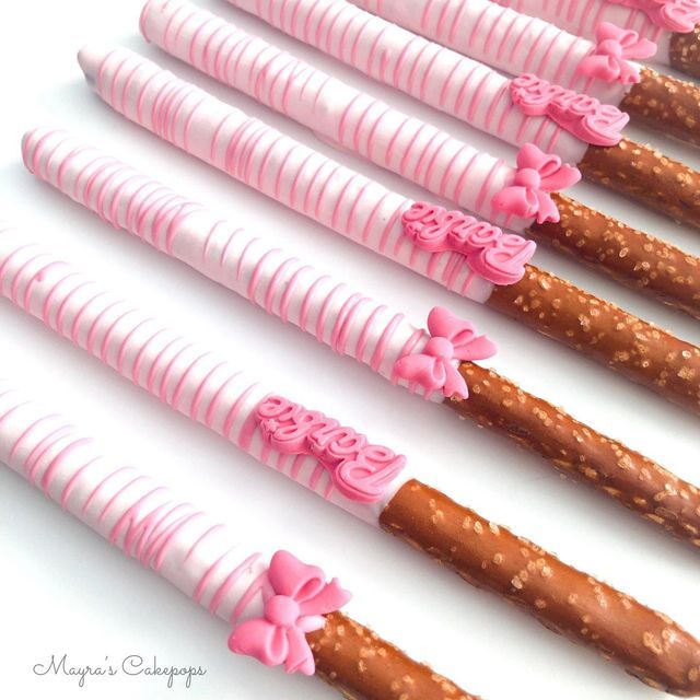 pink and brown candy sticks with bows on them