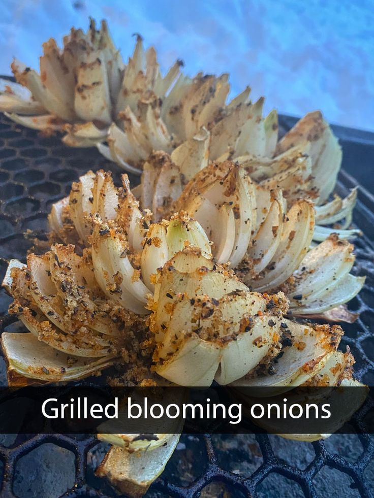 grilled blooming onions on the grill with text overlay that reads grilled blooming onions