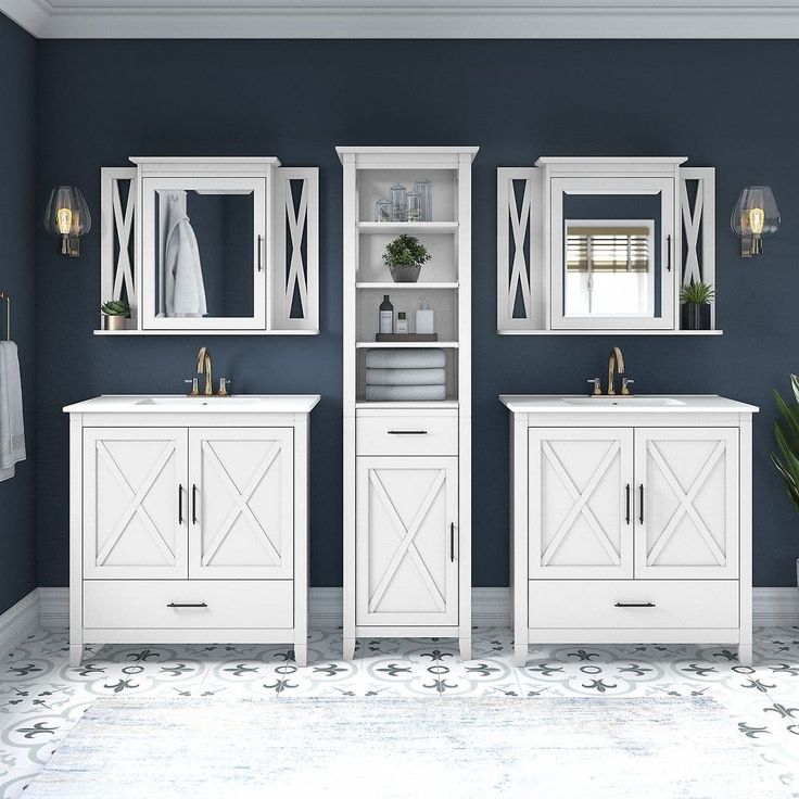 a bathroom with blue walls and white cabinets