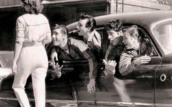 a group of people standing next to a car