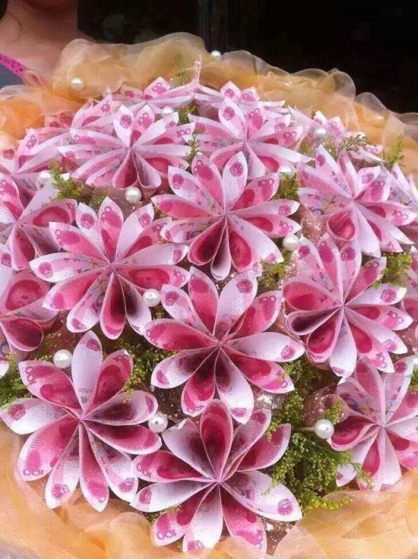 a close up of a pink and white flower arrangement