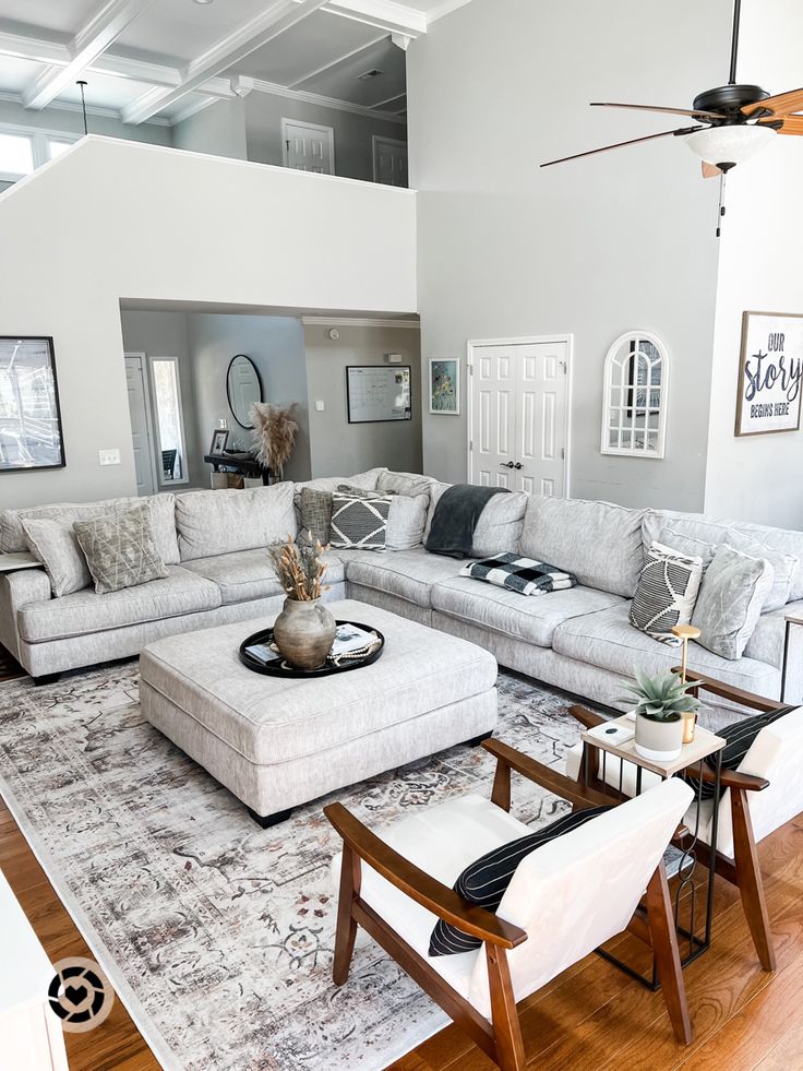 a living room filled with furniture and a ceiling fan