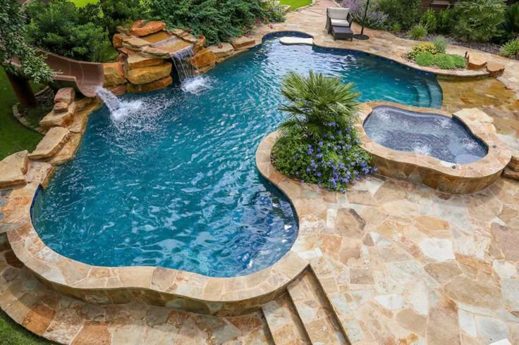 an outdoor swimming pool with steps leading up to it and a waterfall in the middle