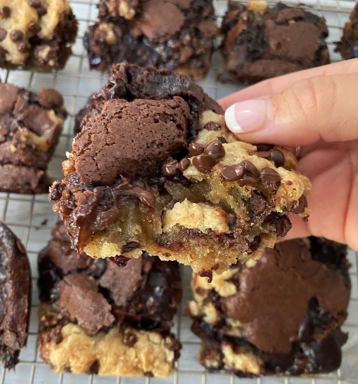 a person is holding up a chocolate chip cookie dough and it's half eaten