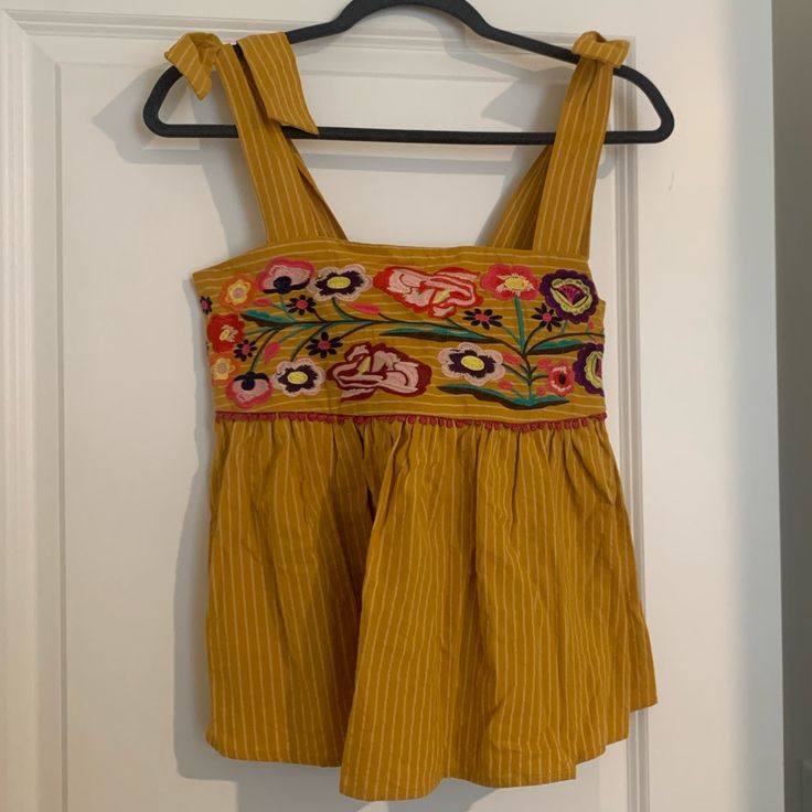 Altar’d State Nwot Size S Top. Beautiful Floral Embroidered Detail. Tie Straps And Cinched Upper Back. This Top Is Perfect For Spring! Yellow Color With Light Stripes Bohemian Yellow Tops With Floral Embroidery, Yellow Bohemian Tops With Floral Embroidery, Yellow Embroidered Beach Top, Yellow Floral Embroidery Tops For Vacation, Yellow Embroidered Top For Beach, Spring Yellow Top With Floral Embroidery, Spring Yellow Floral Embroidered Top, Yellow Floral Embroidered Top For Spring, Yellow Embroidered Top For Vacation