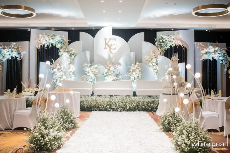 an elegant wedding setup with white flowers and greenery