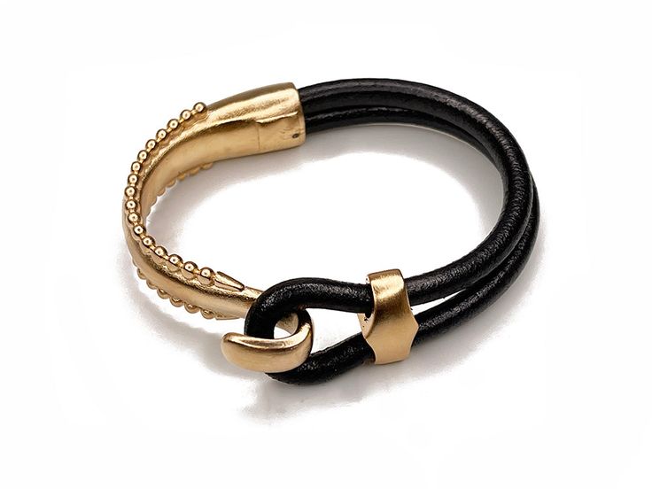 100% genuine black leather with pewter base clasp electroplated in either platinum, gold, antique copper, or antique brass *SIZING: For a proper fit, please measure the circumference of your wrist and enter it in the box above. We will size the bracelet accordingly.